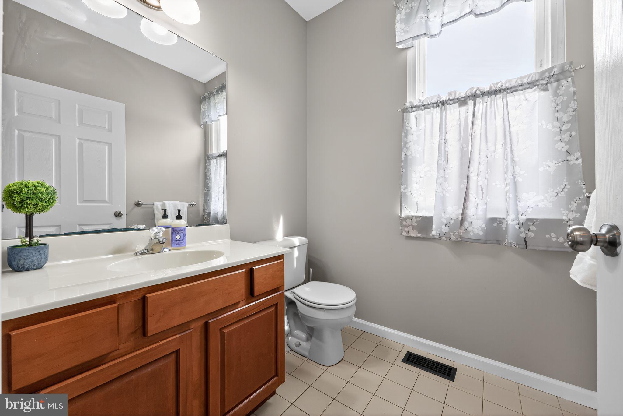 562 Partridge Court Mickleton, NJ 08056 - Photo 15 of 33 a bathroom with a sink a toilet and a mirror