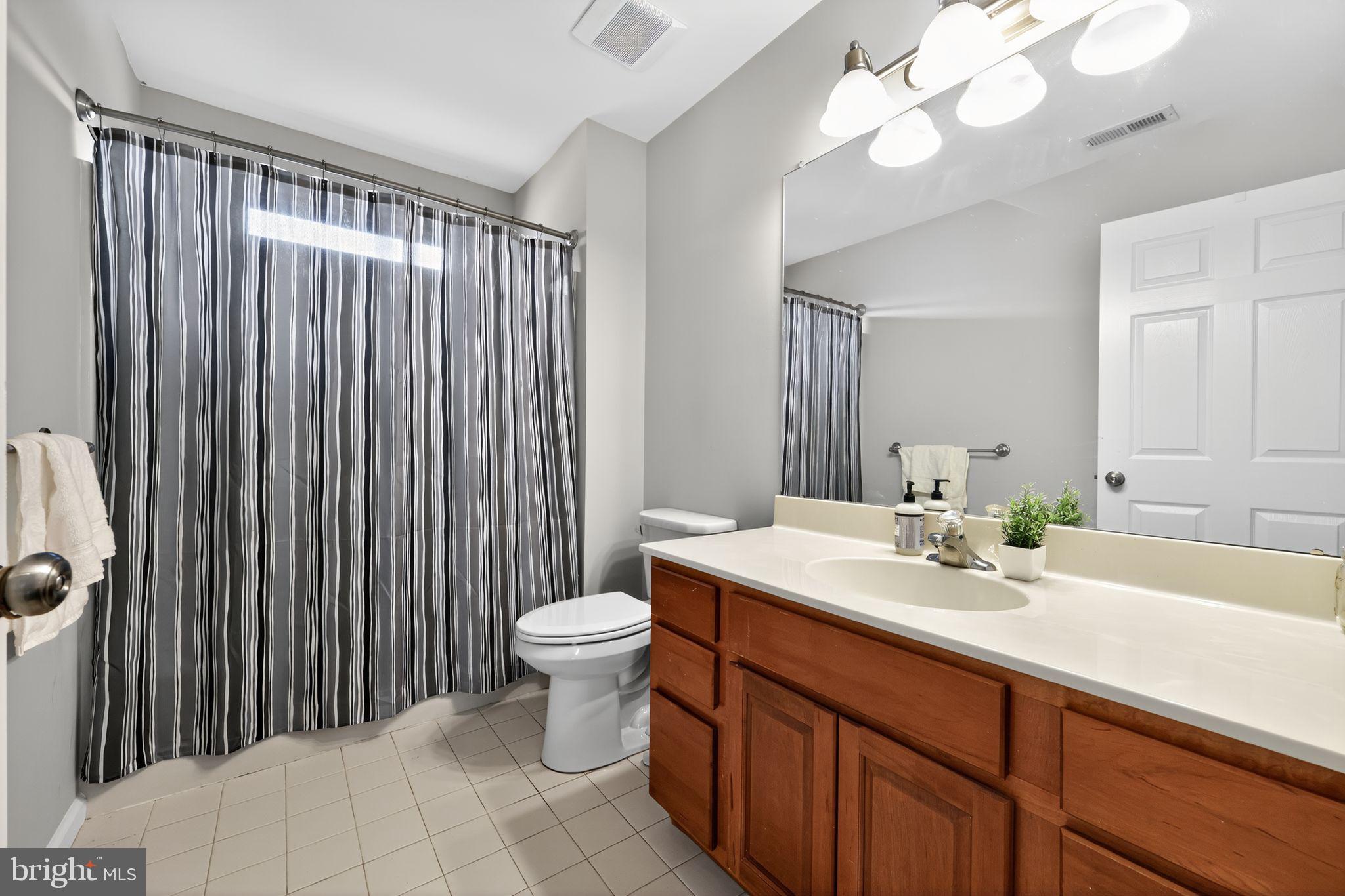 562 Partridge Court Mickleton, NJ 08056 - Photo 21 of 33 a bathroom with a sink a toilet and a mirror