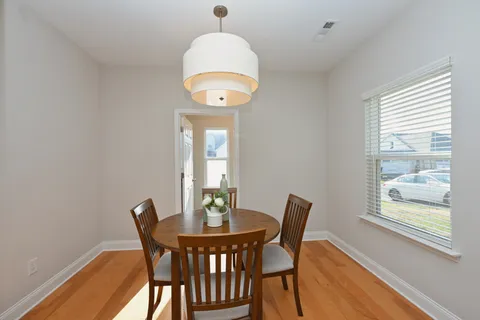 a view of a dining room with furniture wooden floor and chandelier