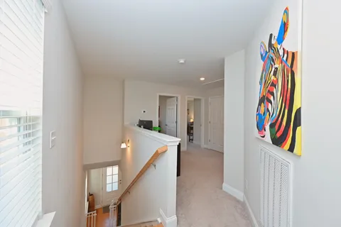 a view of a hallway with front door and wooden floor