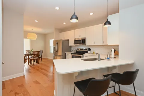 a kitchen with sink cabinets and dining table