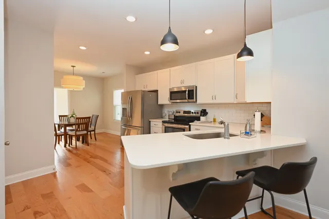 a kitchen with sink cabinets and dining table