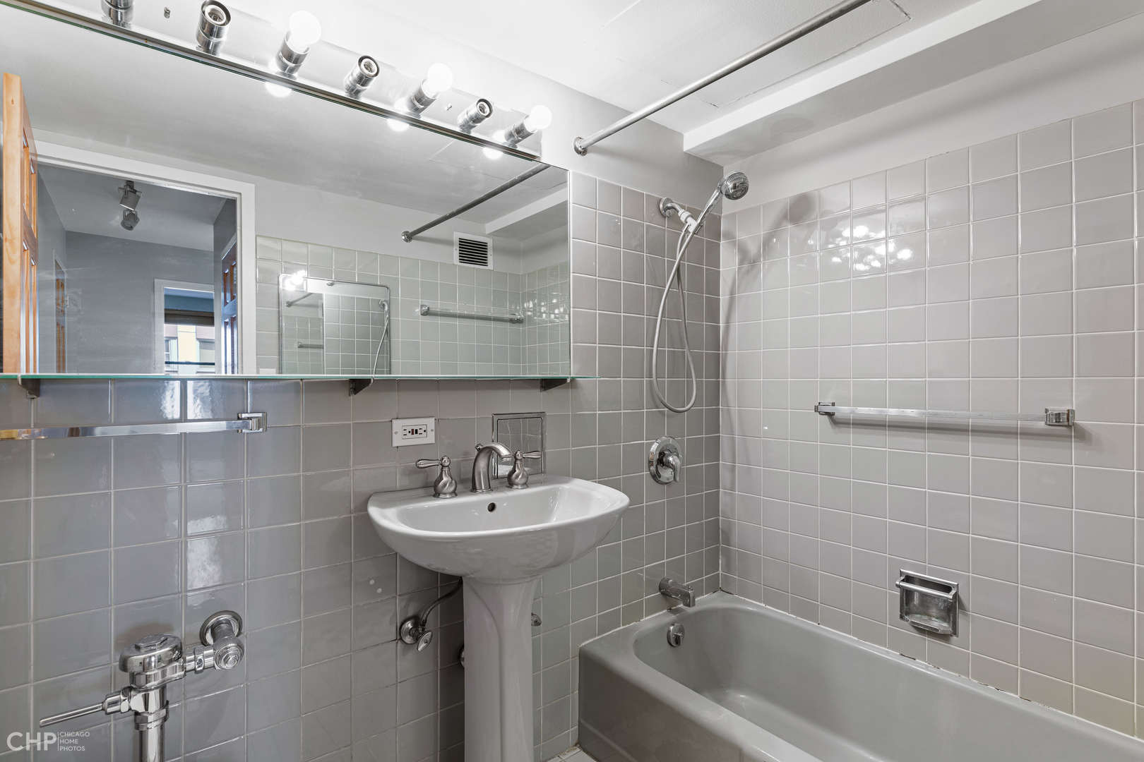 850 North Dewitt Place, Unit 4A Chicago, IL 60611 - Photo 13 of 22 a bathroom with a sink a mirror and shower