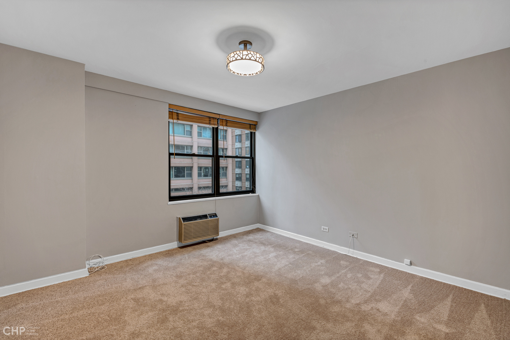 850 North Dewitt Place, Unit 4A Chicago, IL 60611 - Photo 15 of 22 an empty room with windows and cabinet