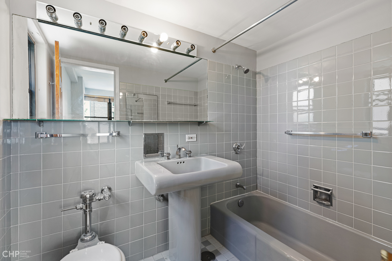 850 North Dewitt Place, Unit 4A Chicago, IL 60611 - Photo 17 of 22 a bathroom with a sink a toilet a mirror and shower