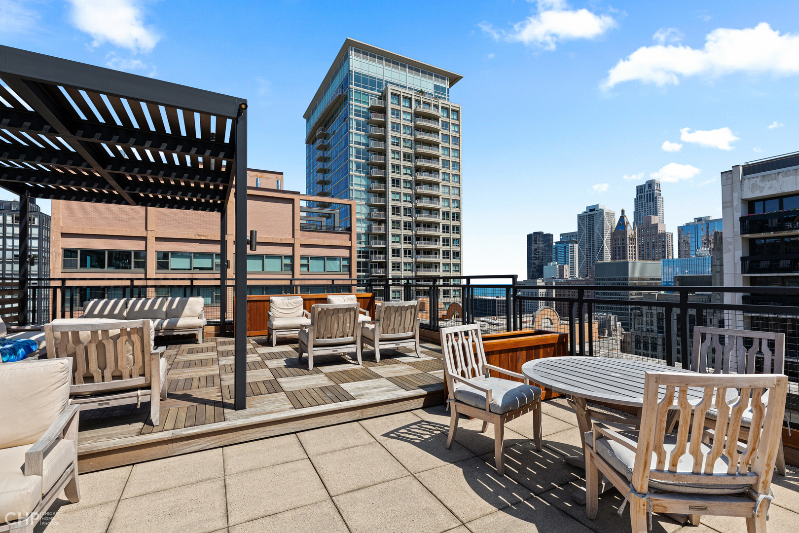 850 North Dewitt Place, Unit 4A Chicago, IL 60611 - Photo 19 of 22 a roof deck with table and chairs