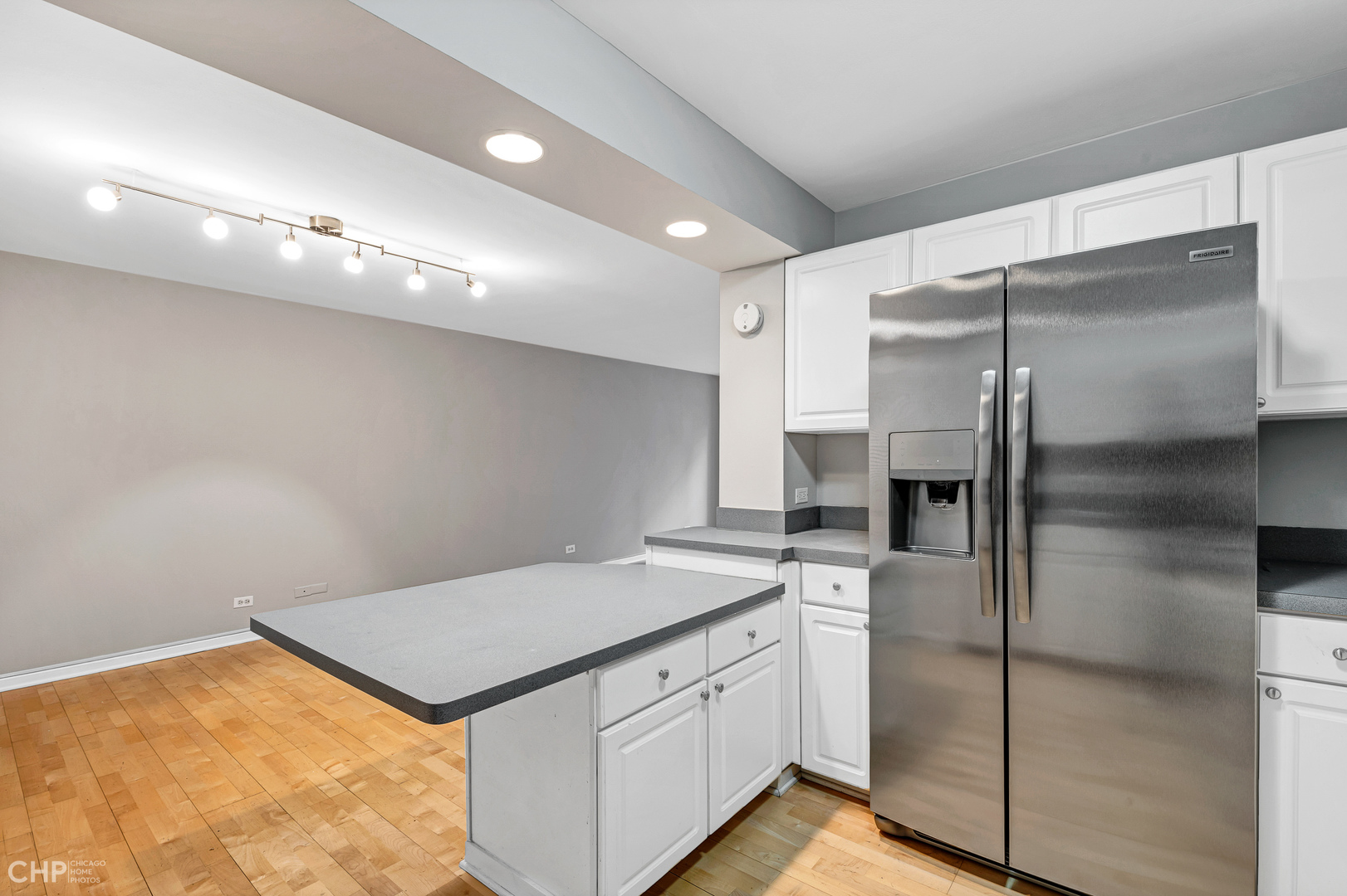 850 North Dewitt Place, Unit 4A Chicago, IL 60611 - Photo 7 of 22 a kitchen with a sink refrigerator and microwave