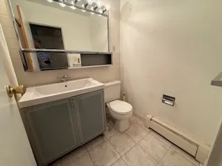 a bathroom with a toilet sink and mirror