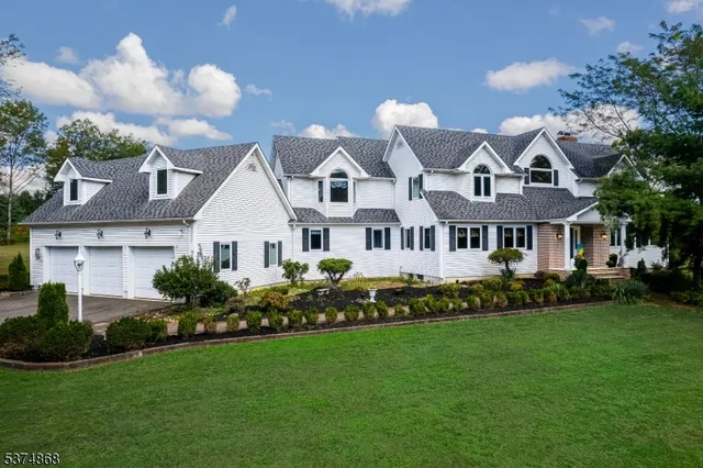 a front view of a house with a garden and plants