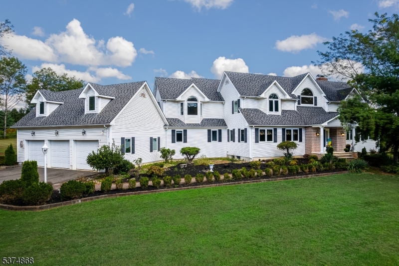 a front view of a house with a garden and plants