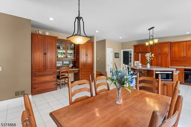 a dining room with furniture and a chandelier