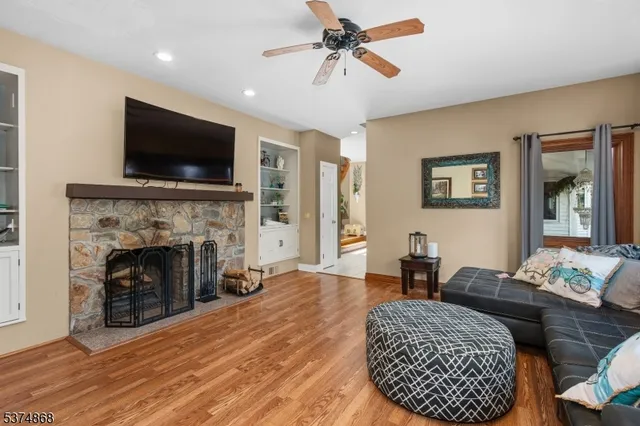 a living room with furniture a flat screen tv and a fireplace