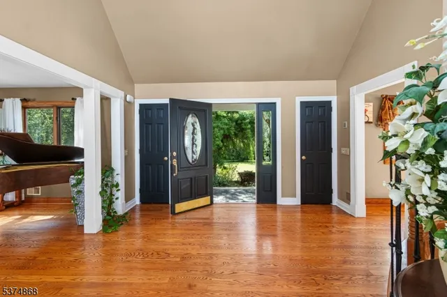 a view of an entryway of a room window and wooden floor