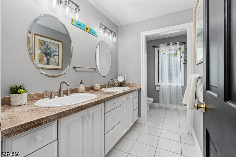 334 West Valley Brook Road Califon, NJ 07830 - Photo 25 of 44 a spacious bathroom with a granite countertop double vanity sink a mirror and a bathtub