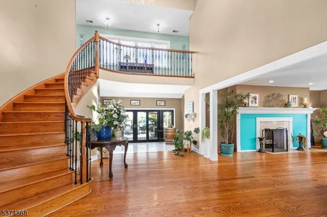 a view of entryway livingroom and hall with wooden floor