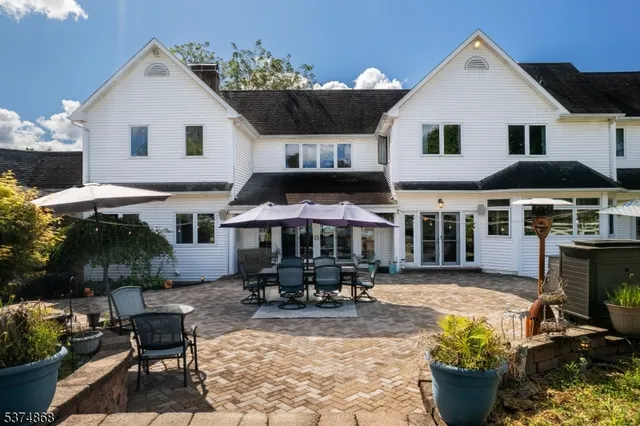 a view of a patio with table and chairs potted plants