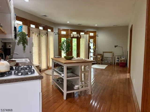 a living room with furniture a large window with wooden floor
