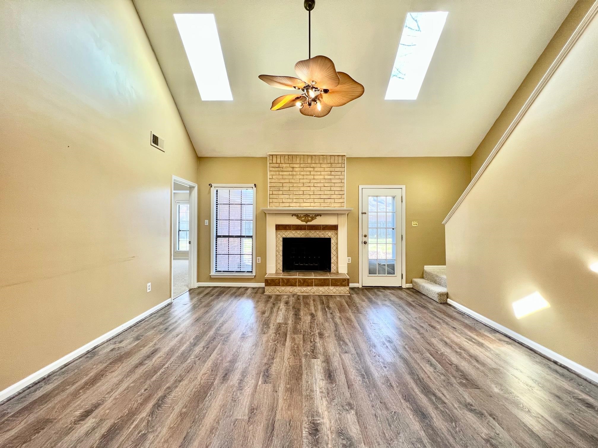 203 Glen Echo Road Collierville, TN 38017 - Photo 4 of 12 wooden floor in an empty room with a fireplace