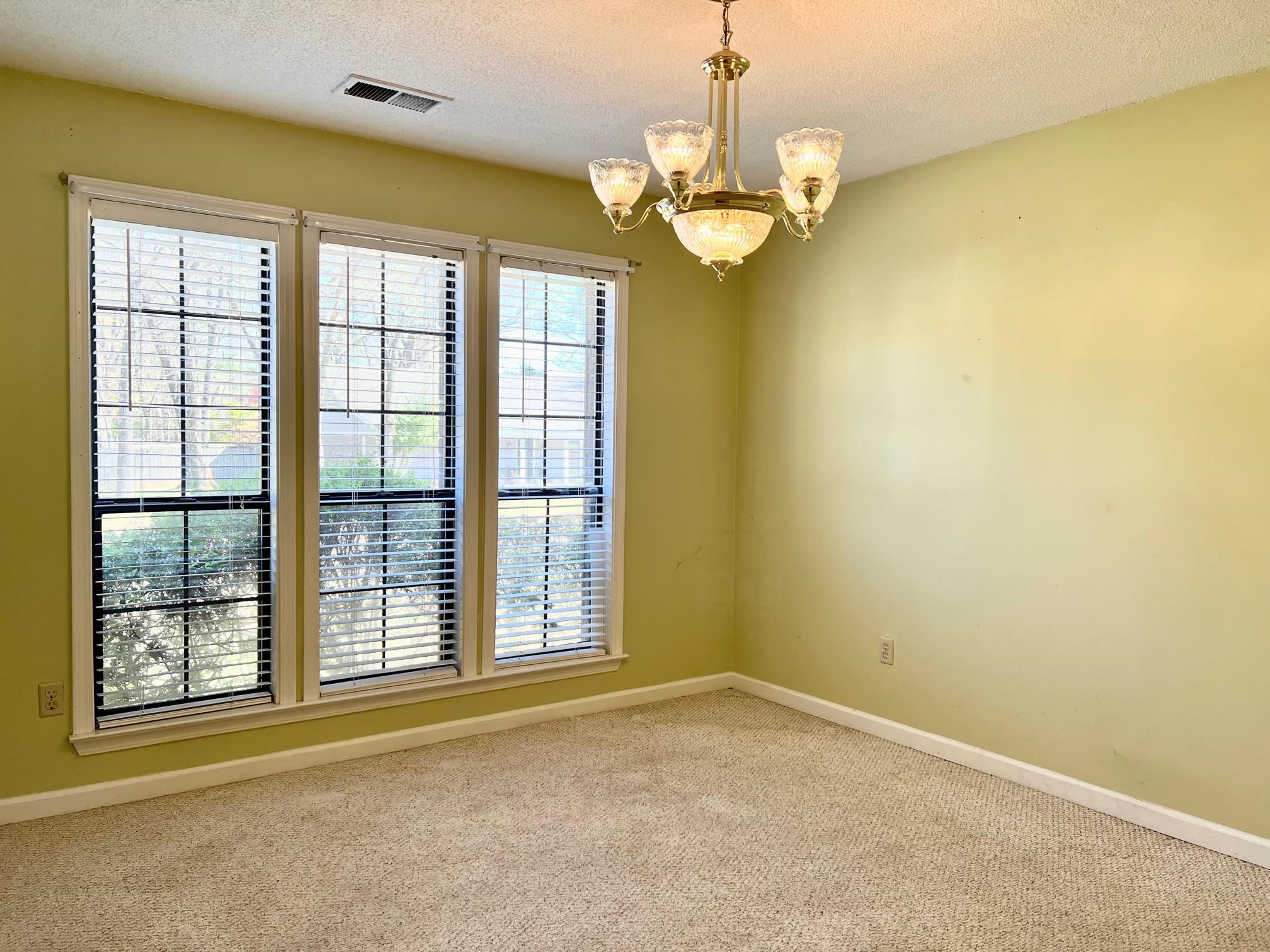 203 Glen Echo Road Collierville, TN 38017 - Photo 6 of 12 a view of a livingroom with a chandelier curtains and large windows