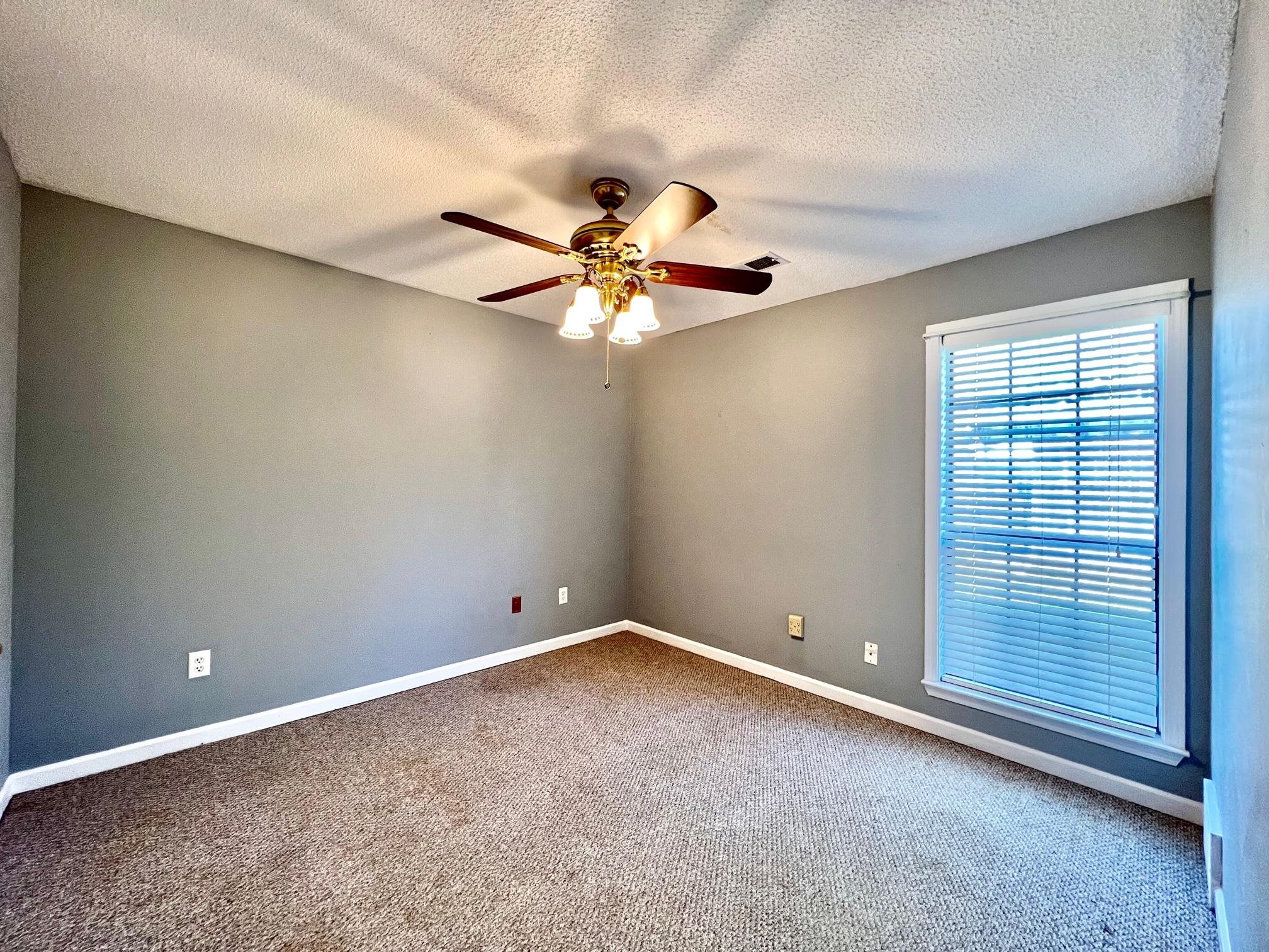 203 Glen Echo Road Collierville, TN 38017 - Photo 9 of 12 an empty room with windows and fan