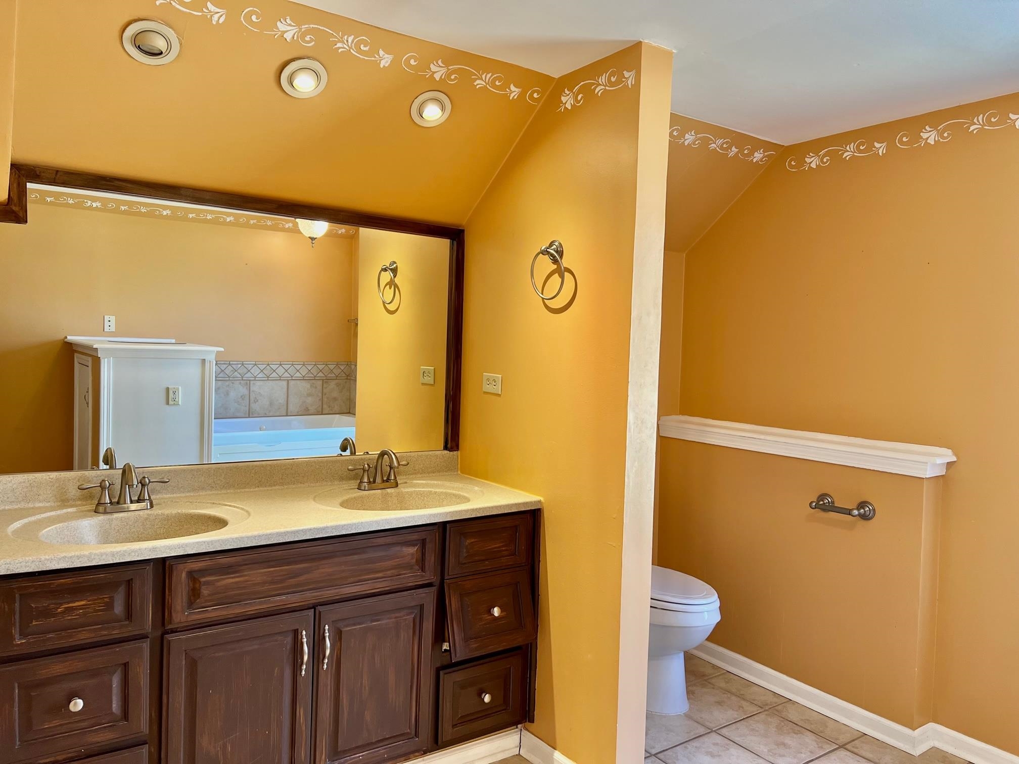 203 Glen Echo Road Collierville, TN 38017 - Photo 10 of 12 a bathroom with a sink mirror and a toilet