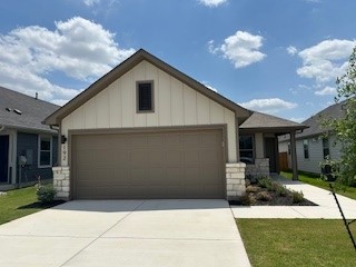192 Spirit Street Elgin, TX 78621 - Photo 1 of 1 View of front of home with a garage, board and batten siding, and driveway