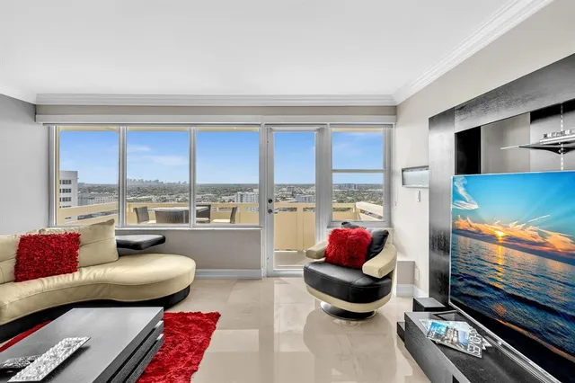 a living room with furniture or couch and a floor to ceiling window