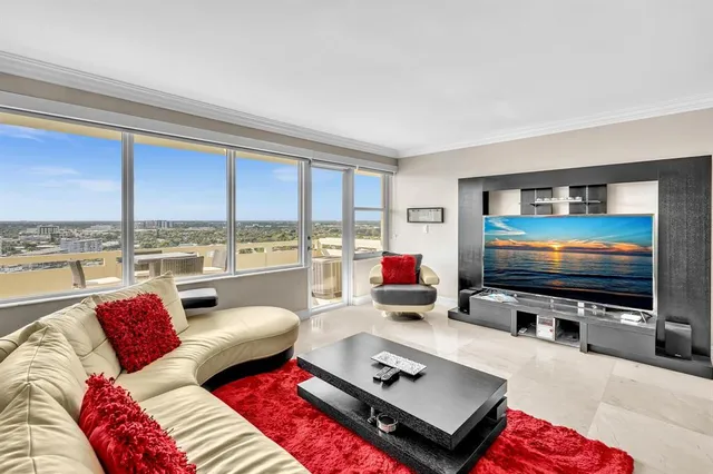 a living room with furniture a rug and a flat screen tv