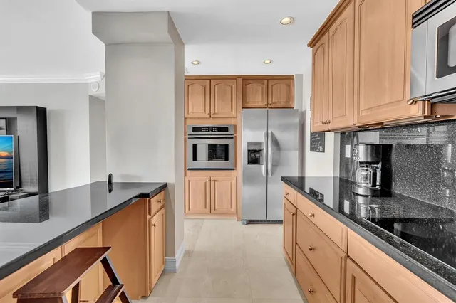 a kitchen with stainless steel appliances a sink a stove and a microwave