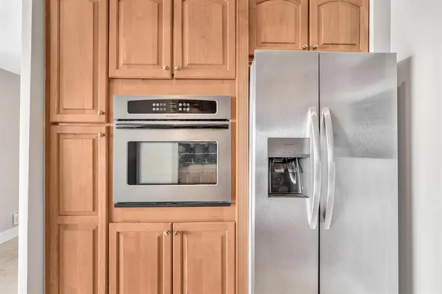 a kitchen with stainless steel appliances granite countertop a refrigerator and a stove