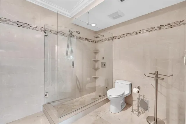 a bathroom with a shower a toilet and sink