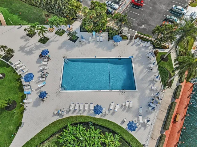 a view of a swimming pool with a bench and a fountain