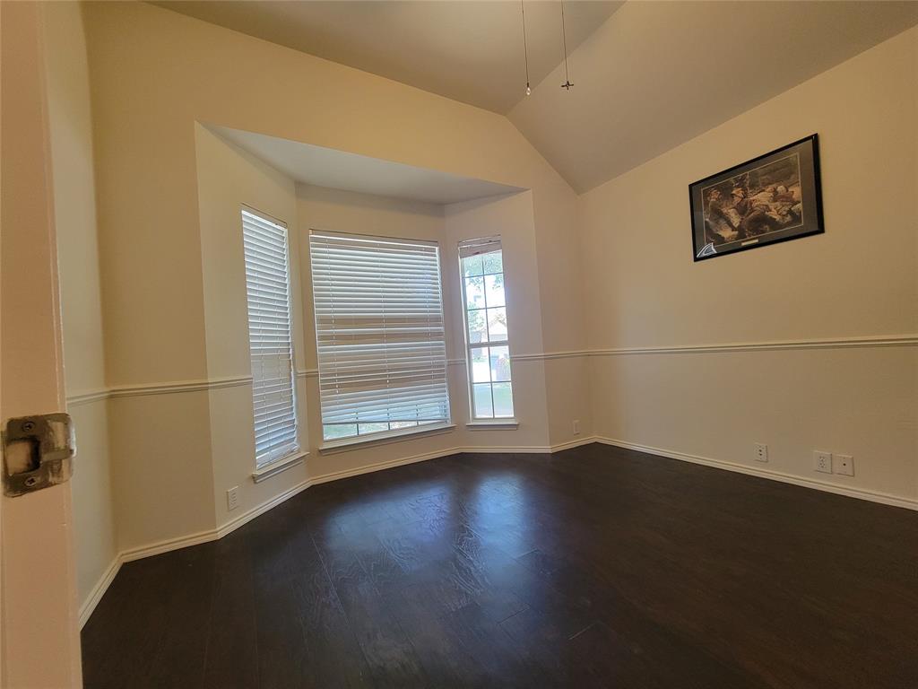 2913 Rush Creek Road McKinney, TX 75072 - Photo 7 of 32 Office with bay window, glass door, and dark wood-style floors, ceiling fan, and lofted ceiling