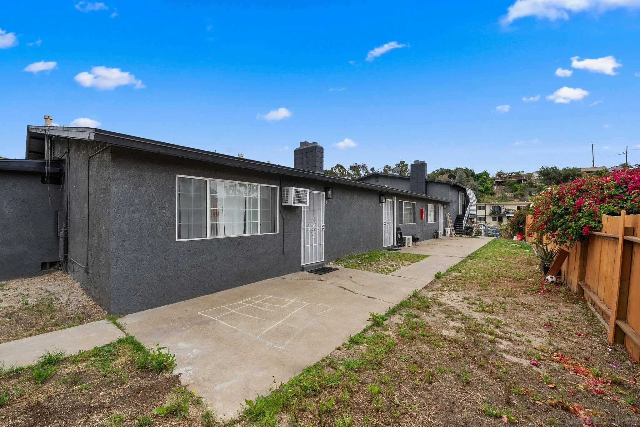 5872-streamview Streamview Drive San Diego, CA 92105 - Photo 11 of 11 a front view of a house with a yard and potted plants