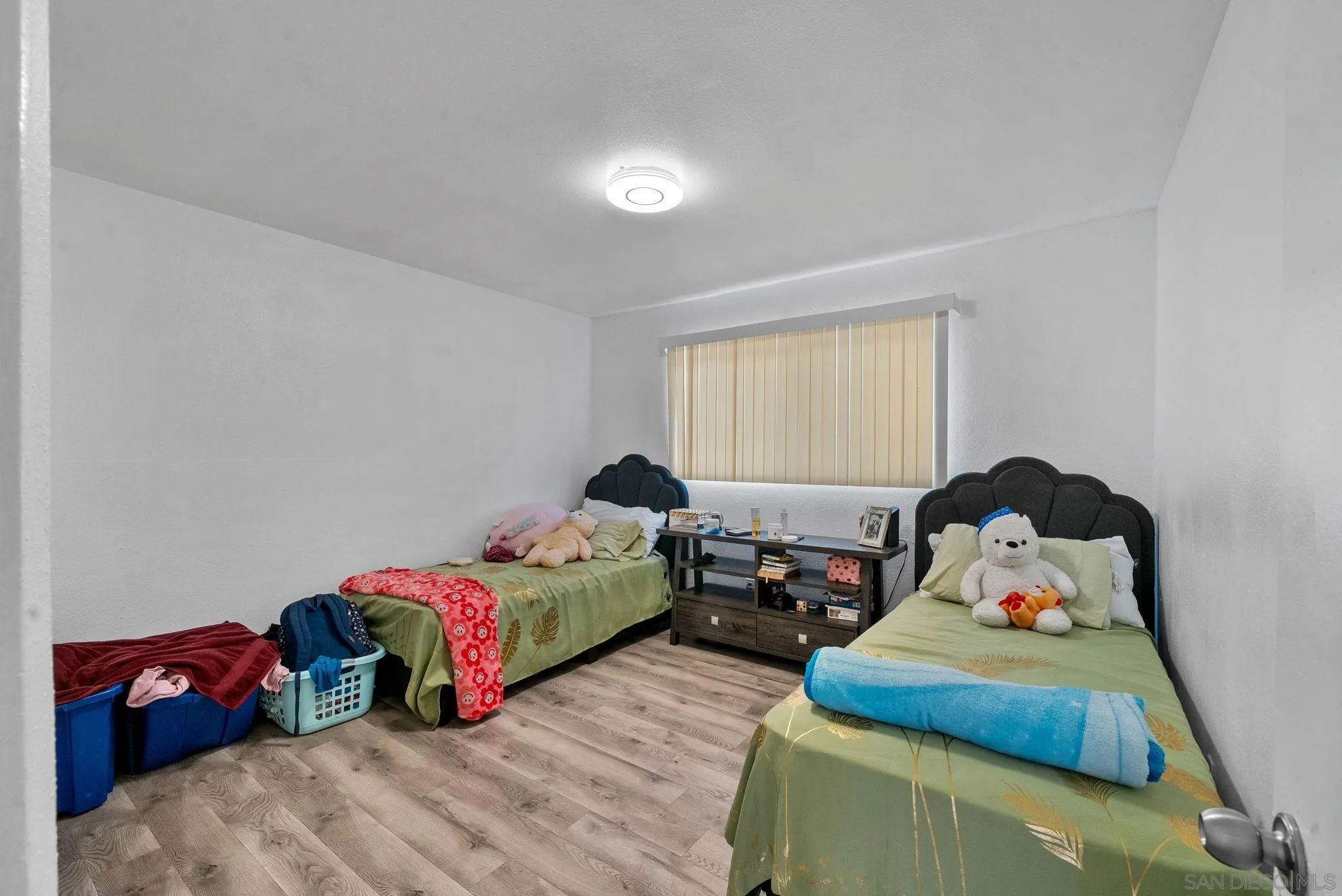 5872-streamview Streamview Drive San Diego, CA 92105 - Photo 6 of 11 a bedroom with two beds and a couch