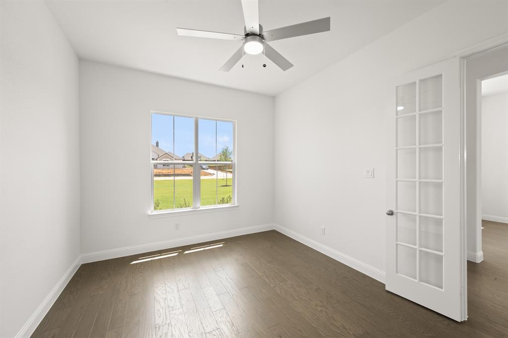 27 Old Crow Road Joshua, TX 76058 - Photo 7 of 35 an empty room with a window and wooden floor