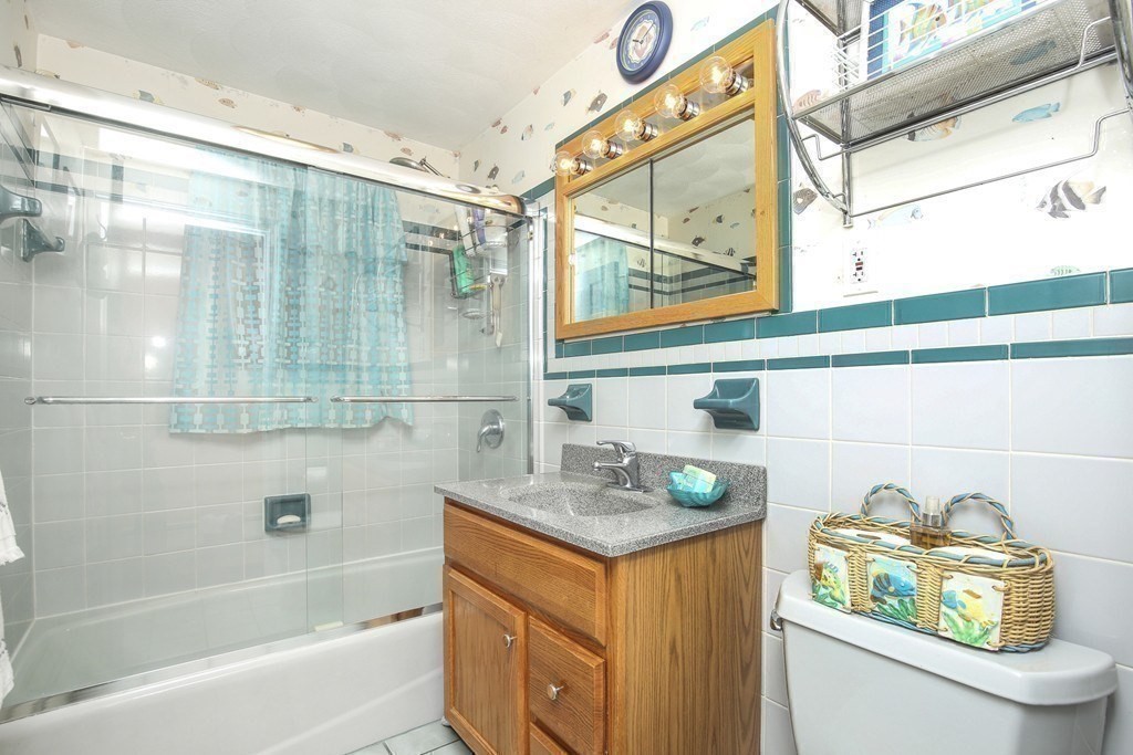 31 Fairchild Avenue Saugus, MA 01906 - Photo 14 of 24 a bathroom with a granite countertop sink a toilet and shower
