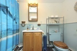 31 Fairchild Avenue Saugus, MA 01906 - Photo 18 of 24 a bathroom with a granite countertop toilet sink and mirror