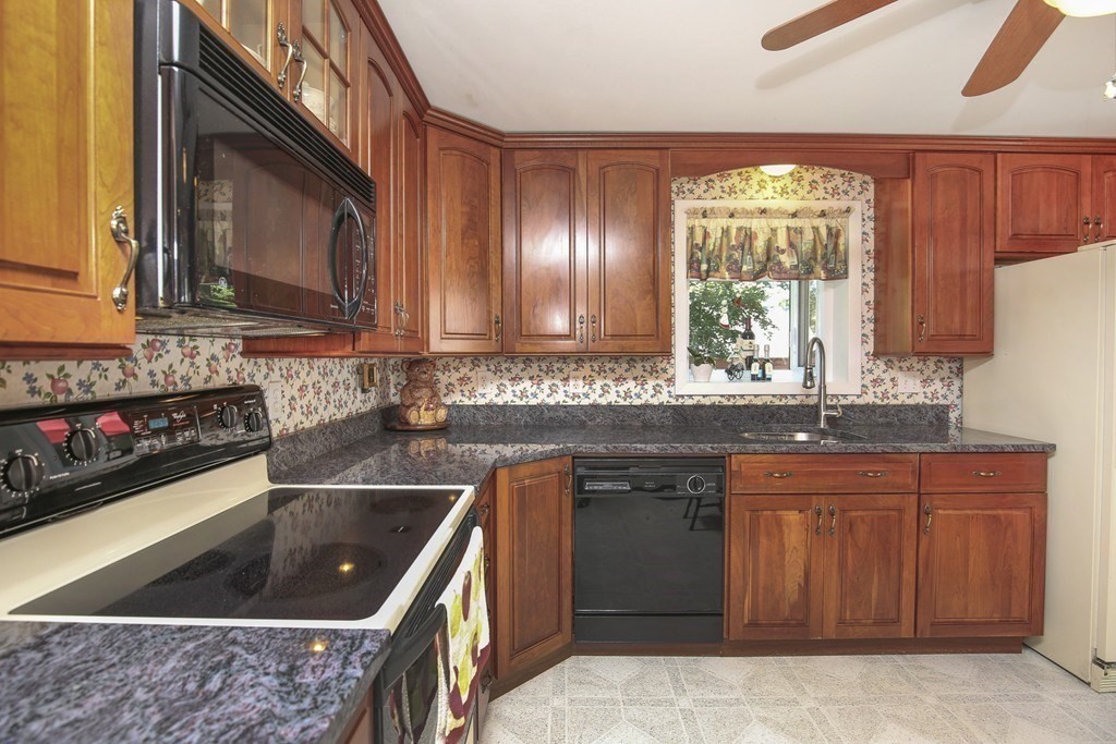 31 Fairchild Avenue Saugus, MA 01906 - Photo 7 of 24 a kitchen with a sink stove top oven and cabinets