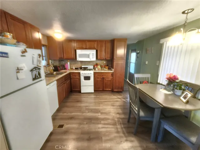 a kitchen with a stove a sink and a refrigerator