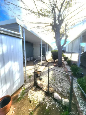 a front view of a house with a lots of windows and plants