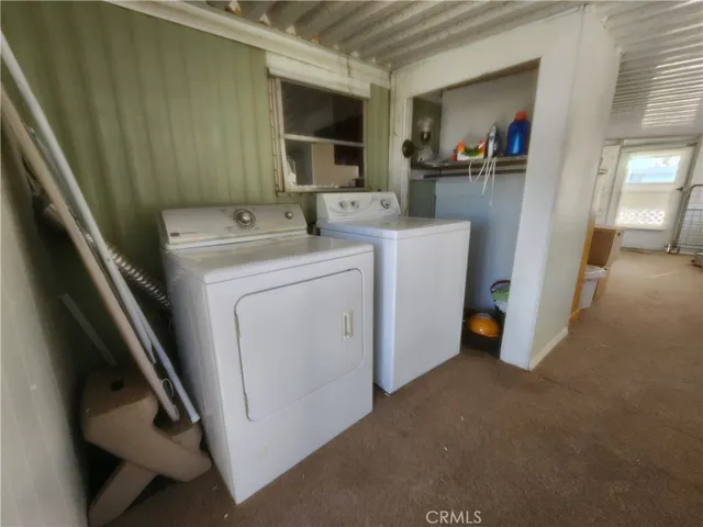 a view of storage and utility room with washer and dryer