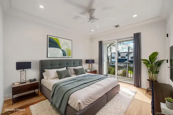 a bedroom with a balcony a bed and a lamp on table
