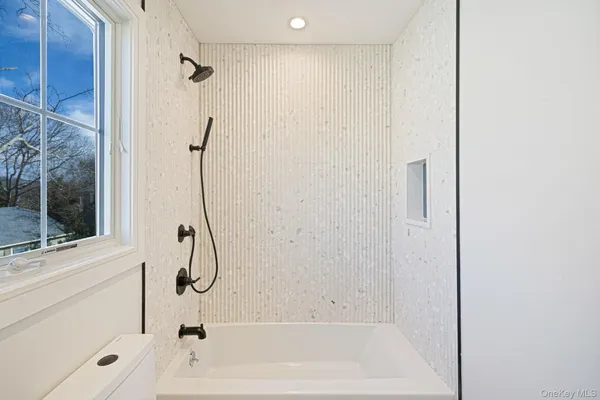 a bathroom with a bathtub and a shower