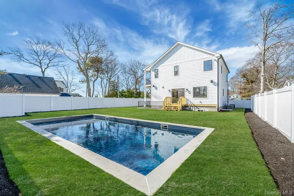 a view of a house with a yard and sitting area