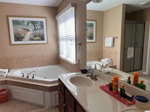 a bathroom with a tub sink and mirror