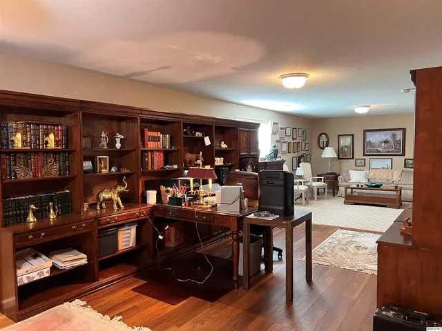 a living room with lots of furniture and wooden floors