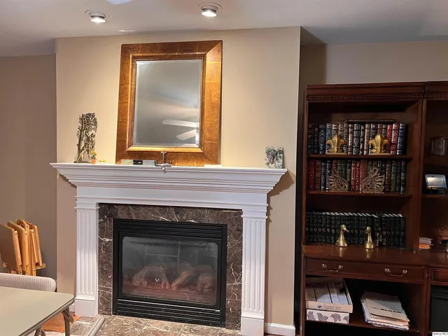 a living room with a fireplace and a window