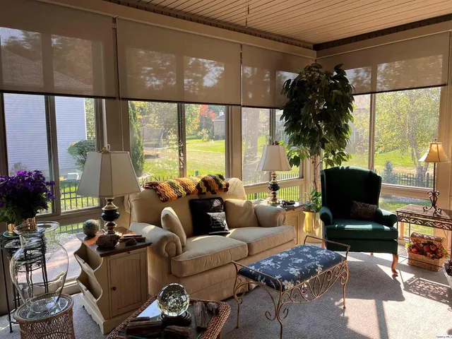 a living room with furniture and a large window