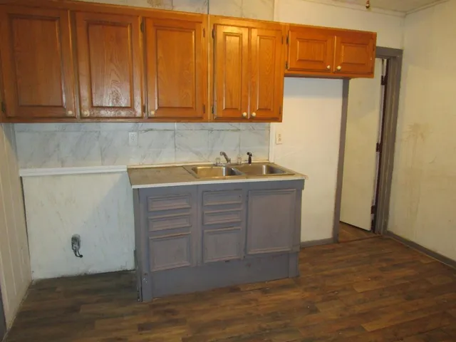 a kitchen with cabinets appliances and a counter top space